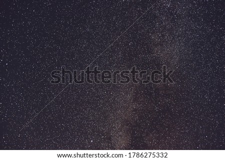 Milky Way  and satellite in the night sky.