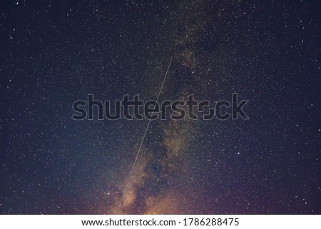 Milky Way  and satellite in the night sky.