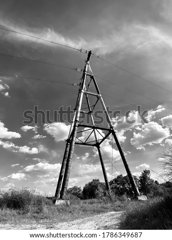 a red and white electric tower on blue sky background