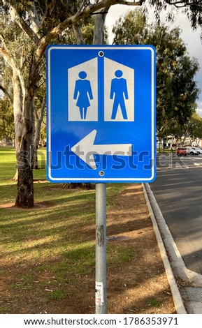 Restroom toilet sign. Australia Park background with clipping path
