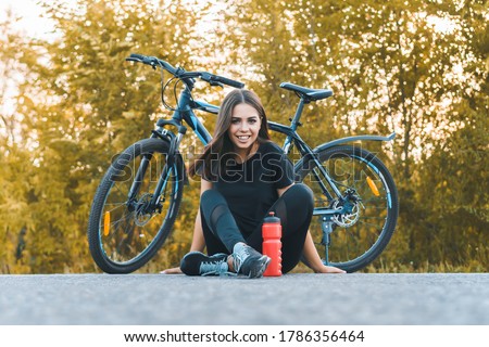 Yound woman on a bike ride in the country. Healthy lifestyle concept