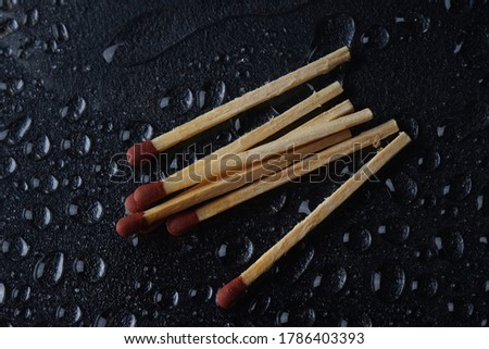 Matches on Dark background with water drops 
