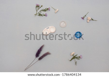 lenses on the table, wear contact lenses, good to see, health concept, take care of eye health, light background, flowers on the background