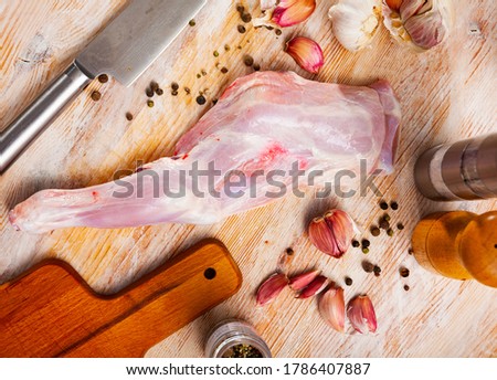 Close up of raw shoulder of goat on wooden surface, nobody