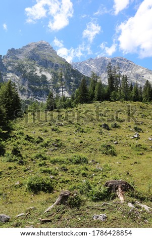 Watzmann mountain peak with blue sky and clouds in summer. National Park Berchtesgaden Land. Bavaria. Germany