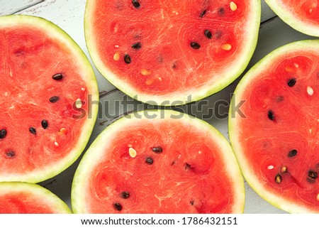 Close-up round slices of watermelon on the white wooden Provence style table.