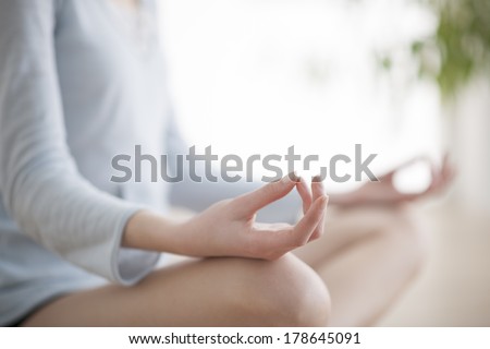 Woman meditating in the lotus position closeup Royalty-Free Stock Photo #178645091