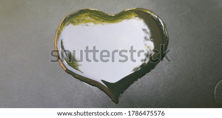 Heart of honey on a dark background (silhouette, top view).