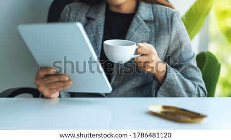 Closeup image of a business woman using digital tablet in office