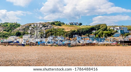 A panorama view of the old town beach in Hastings, Sussex with the west cliff backdrop in summer Royalty-Free Stock Photo #1786488416