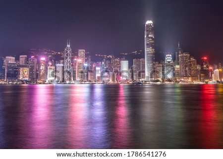 The incredible night cityscape view of lights on the water on Victoria Harbour in Hong Kong