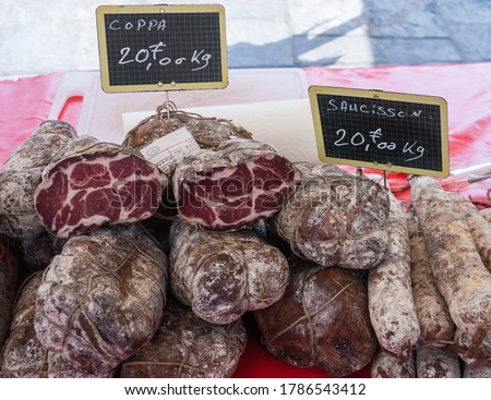 Artisanal specialty sausages (coppa, saucisson) for sale at a market in Bastia, Corsica, France