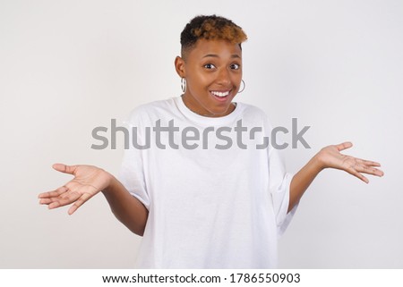 So what? Portrait of arrogant unbothered good-looking modern young stylish African American woman, shrugging careless hands sideways smiling gasping indifferent, telling something obvious. Royalty-Free Stock Photo #1786550903