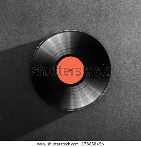 Black vinyl record on a dark background
