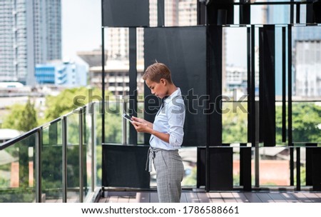 Side view of woman standing in urban city terrace stock photo
