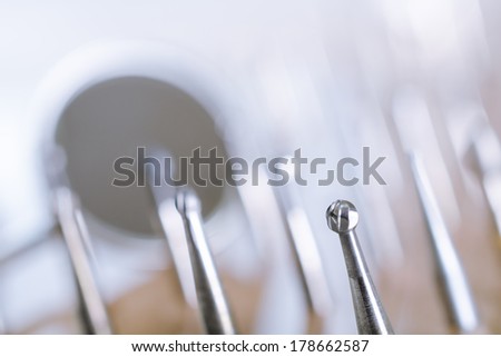 Set of dental drills with mirror in the background. Close up