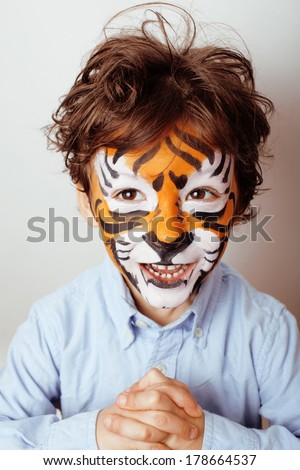 little cute boy with faceart on birthday party close up