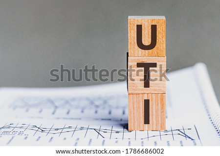 Wooden block with words UTI - acronim UTI - User Task Interface. Concept image of User Task Interface UTI.
