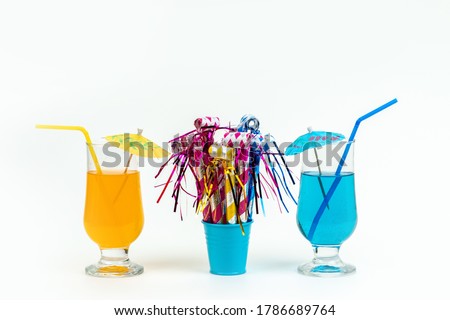 a front view iced coktails colorful with straws along with birthday whistles on the white background drink juice color