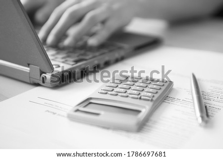 Black and white photo of man doing taxes and working from home
