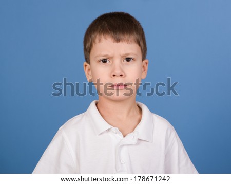 serious boy portrait on blue