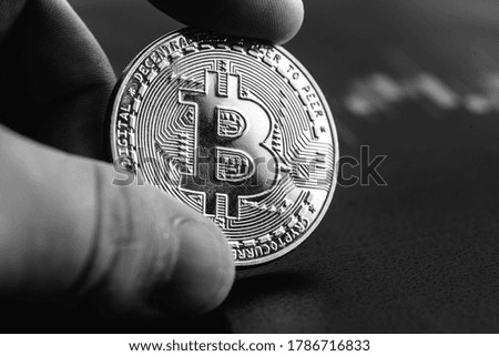 Bitcoin in hands close-up. Cryptocurrency rate. High quality photo