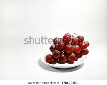 a berry red grape fruit on the dish 