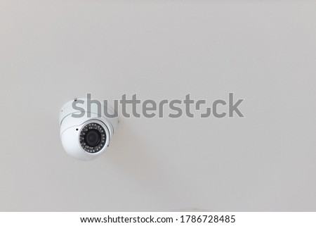 Security CCTV camera surveillance system indoor of house. A blurred night Cityscape background. Modern CCTV camera on a wall. Equipment system service for safety life or asset.