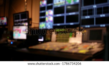Professional sound engineer's console. Television Broadcast, working with video and audio mixer, control broadcast in recording studio. blurred background, monitors.