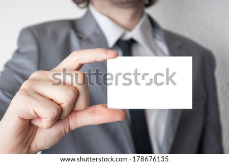 Businessman holding and showing an empty card