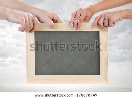 Close up of human hands holding blank frame