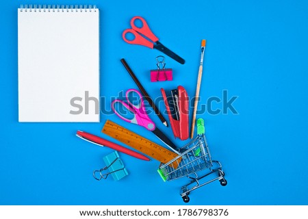 Trolley with office supplies on a blue background. High quality photo