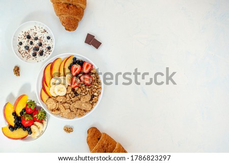 Summer breakfast with granola, croissant yoghurt and berries on a light background. Flatly.
