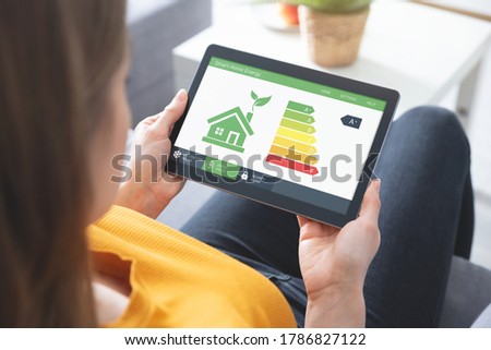 Energy efficiency mobile app on screen. Ecology, eco house concept Royalty-Free Stock Photo #1786827122