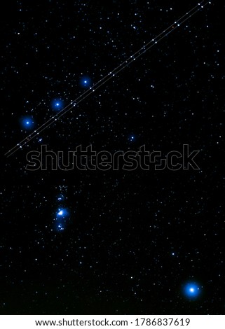 Plane crossing the Orion Constellation, night sky