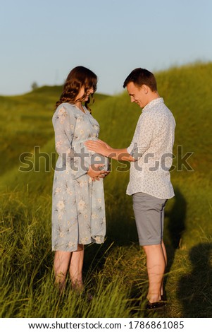 Portrait of a pregnant woman with her boyfriend. Happy couple expecting a baby, young family concept