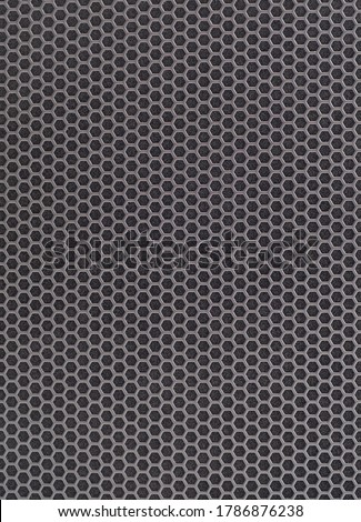 Black iron musical powerful speaker with a protective grill texture. Metal grid background.  