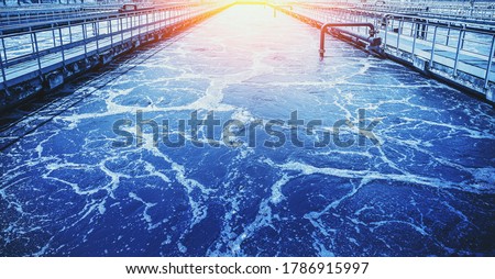 Water treatment tank with wastewater, aeration process in blue color Royalty-Free Stock Photo #1786915997