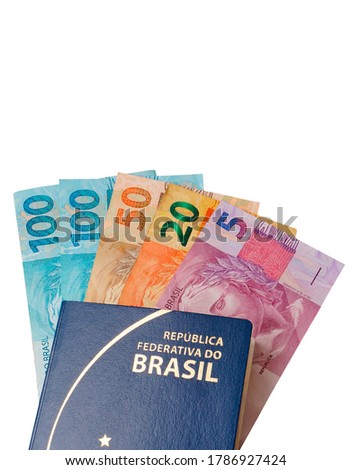 Translation: Federative Republic of Brazil. Mercosur passport. / Brazilian passport and Brazilian money isolated on white background. Travel concept. Vertical photo.