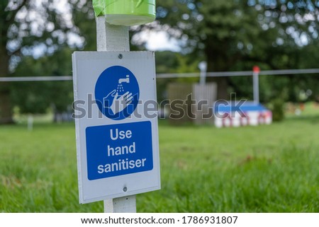 A sign asking visitors to use hand sanitiser at an outdoor equestrian event as the coronavirus lockdown eases in England