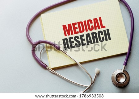 On a purple background a stethoscope with yellow list with text MEDICAL RESEARCH