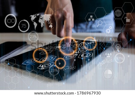 Double exposure of businesswoman working on tablet and business financial virtual chart, Digital network marketing concept, Background toned image blurred.