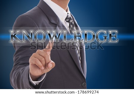 Businessman hand pushing knowledge button on virtual screens 