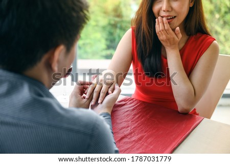 Close up of engaged couple with diamond ring. Wedding and relationships concept