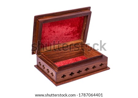 Wooden open carved box handmade with red velvet inside. Indian culture. Isolated on a white background.