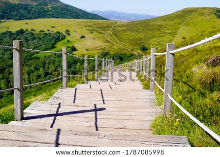 wooden walking path in puy de dome french mountains in summer day Royalty-Free Stock Photo #1787085998
