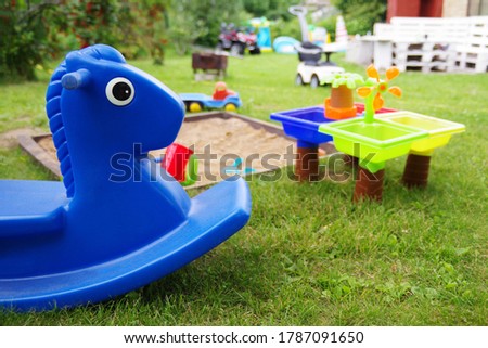 Close-up of children's sandbox in a playground that have a lot of colorful plastic toys for kids