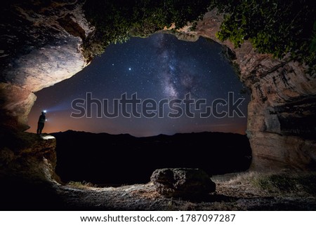 milky way inside a cave with plants and starry sky