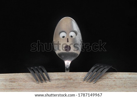               spoon and forks look like person  with  face waiting  for food  funny                 