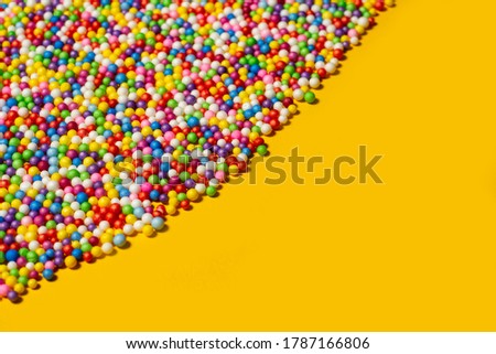 Background texture of multicolored foam balls.
Scattering of  bright foam balls